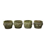 A SET OF FOUR RECONSTITUTED STONE GARDEN PLANTERS