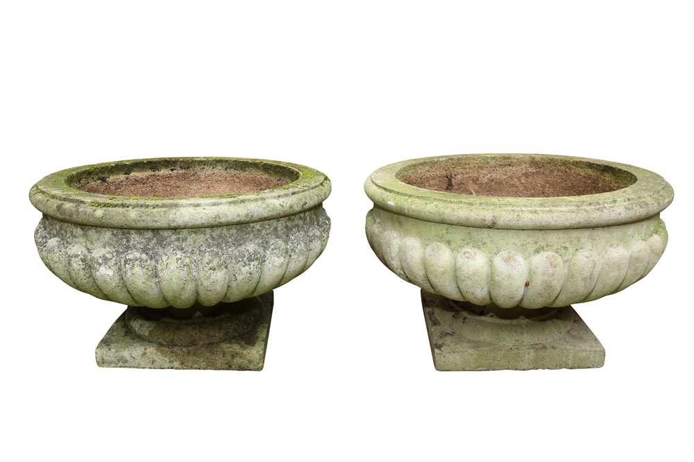 A PAIR OF RECONSTITUTED STONE GARDEN URNS