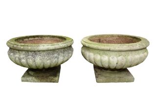 A PAIR OF RECONSTITUTED STONE GARDEN URNS