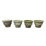 A SET OF FOUR RECONSTITUTED STONE GARDEN PLANTERS