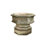 A RECONSTITUTED STONE FONT GARDEN PLANTER