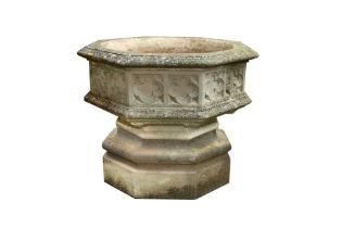 A RECONSTITUTED STONE FONT GARDEN PLANTER