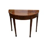 A GEORGE III FLAME MAHOGANY DEMI LUNE FOLD OVER CARD TABLE