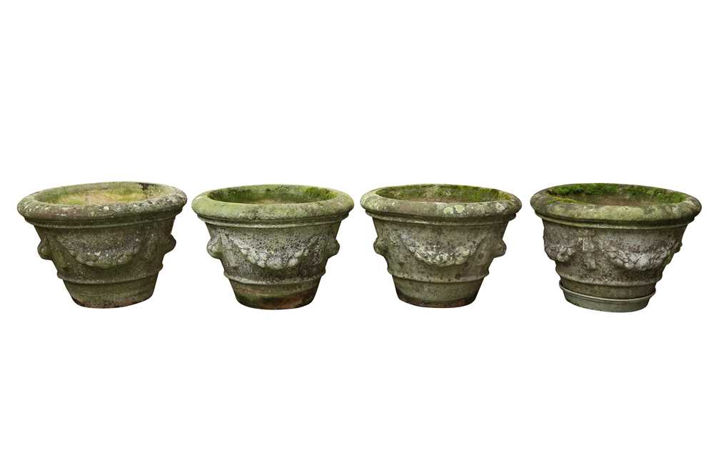 A SET OF FOUR RECONSTITUTED STONE GARDEN PLANTERS