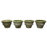 A SET OF FOUR RECONSTITUTED STONE GARDEN PLANTERS