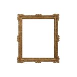 A FRENCH OAK RÈGENCE CARVED AND GILDED FRAME