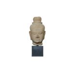 A KHMER CARVED BUFF SANDSTONE HEAD OF THE HINDU GOD SHIVA Cambodia, South East Asia, Baphuon Style,
