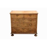 A GEORGE I WALNUT AND FEATHERBANDED CHEST OF DRAWERS