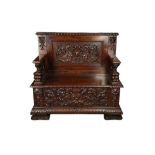 A 19TH CENTURY ORNATELY CARVED MAHOGANY SETTLE