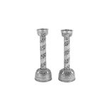 A pair of mid-20th century Tibetan unmarked silver picket candlesticks, circa 1950
