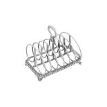 A George IV sterling silver seven bar toast rack, London 1829 by Benjamin Smith III