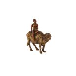 A GILT BRONZE FIGURE OF A YOUNG BOY RIDING A BUFFALO Germany, early to mid 20th century