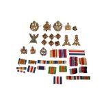 A COLLECTION OF CAP BADGES AND MEDAL RIBBONS