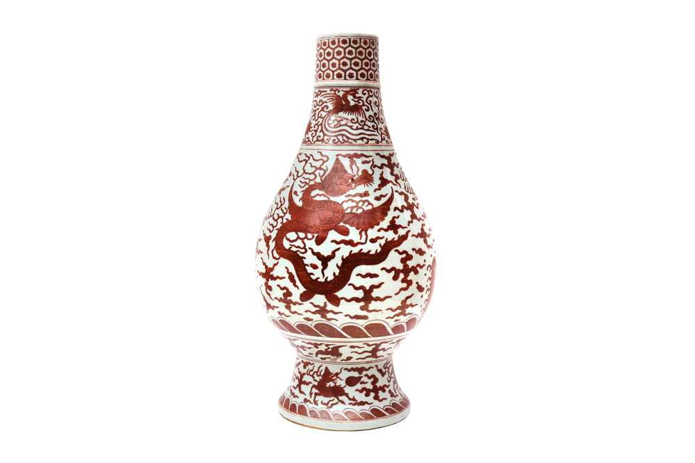 A LARGE CHINESE IRON RED-DECORATED 'DRAGON AND PHOENIX' VASE