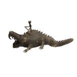 AN INDIAN BRONZE DHOKRA FIGURE OF A CROCODILE AND RIDER.