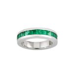 An emerald half-hoop ring