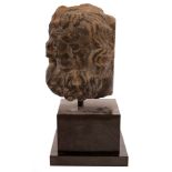 A 14th/15th Century carved stone head, probably French, modelled as a bearded saint,