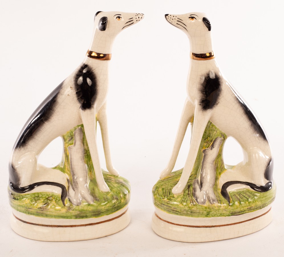 A pair of Staffordshire greyhounds each with a gilt collar and hare, on an oval base, 23. - Bild 2 aus 3