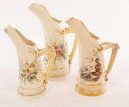 Two Royal Worcester tusk-shaped jugs, each with branch type handles,