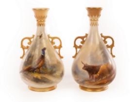 Two Royal Worcester vases, each with pierced gilt handles,