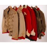 A collection of military uniforms, jackets, trousers, waistcoats etc.