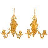 A pair of French re-gilded metal wall lights,