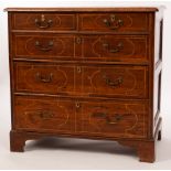 A George I yew wood chest, of two short and three long graduated drawers,