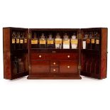 An apothecary's mahogany cabinet, 19th Century, enclosed by a pair of doors,