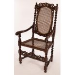 A 17th Century Franco-Flemish carved walnut armchair with cane back and seat,