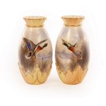 A pair of Royal Worcester baluster vases with gilt rimmed frilled necks and gilt edged foliate band