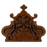 An Elizabeth I style carved oak pediment with a central horned mask issuing swags of fruit to