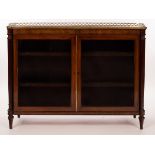A Regency mahogany side cabinet with a brass galleried top and banded border enclosed by a pair of