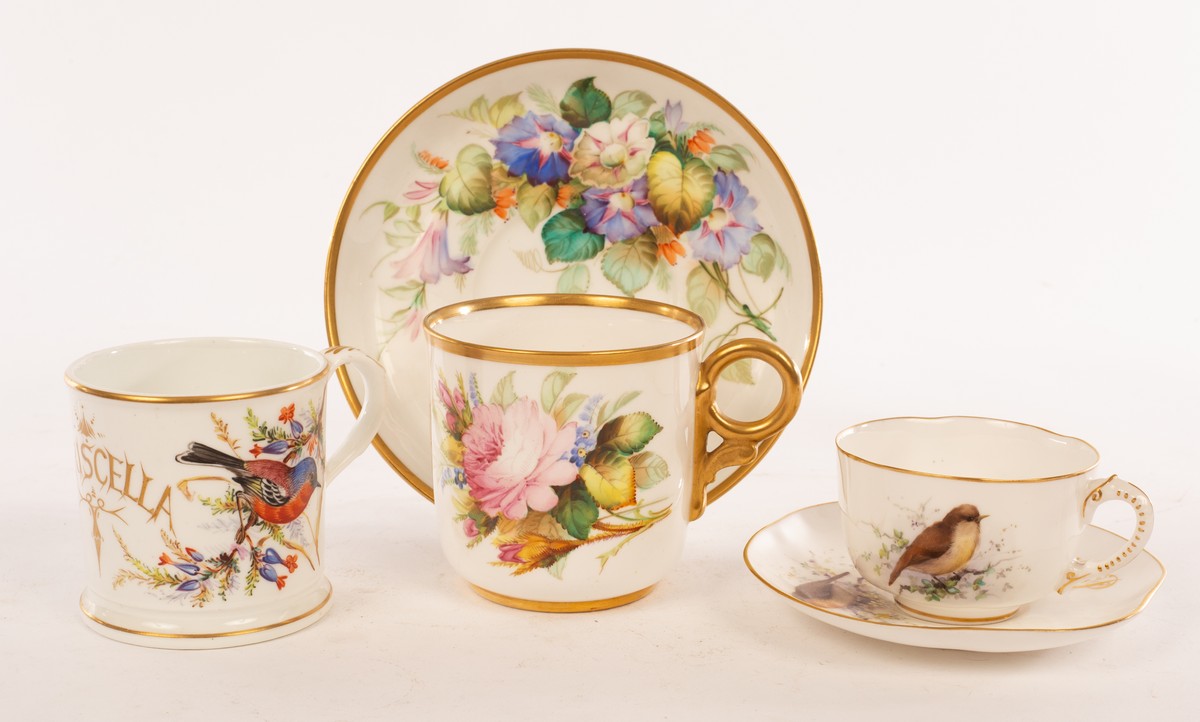 A Royal Worcester cup and saucer painted brightly coloured flowers and initialled WHW in gilt,