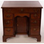 A Georgian mahogany kneehole desk, with eight drawers and kneehole cupboard, 78.