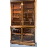 An early Victorian rosewood and brass inlaid bookcase, the cornice lacking,