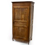 A French provincial walnut, fruitwood and burr walnut armoire, enclosed by a single panelled door,