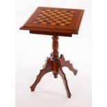 A Victorian mahogany tripod table, inlaid for chess on a turned column and quadruple support,