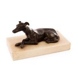 A bronze figure of a recumbent whippet, the white marble plinth 20cm x 11cm,