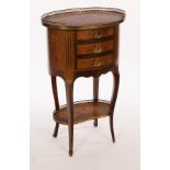 A French late 19th Century walnut and marquetry oval chest with brass gallery surround,