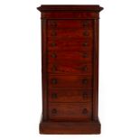 A mahogany Wellington chest with cushion top, fitted eight drawers with hinged pillars to the sides,