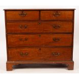 A George III mahogany chest of two short over three long drawers, on bracket feet,