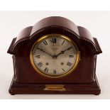 An Edwardian mahogany eight-day mantel clock in an arch top case,