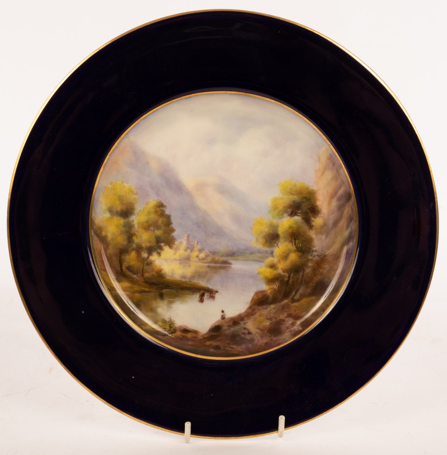 A Royal Worcester plate, 1922, painted a lake and mountain landscape by James Stinton, signed,