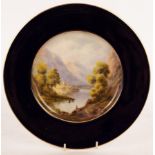 A Royal Worcester plate, 1922, painted a lake and mountain landscape by James Stinton, signed,