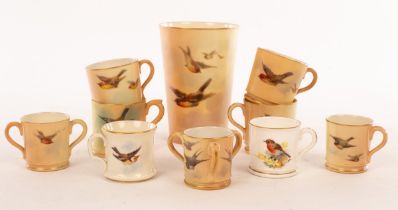 A Royal Worcester miniature loving cup with three handles, painted swallows in flight, 4cm high,