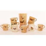 A Royal Worcester miniature loving cup with three handles, painted swallows in flight, 4cm high,