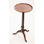 A mid 19th Century circular table on a turned column with tripod support,
