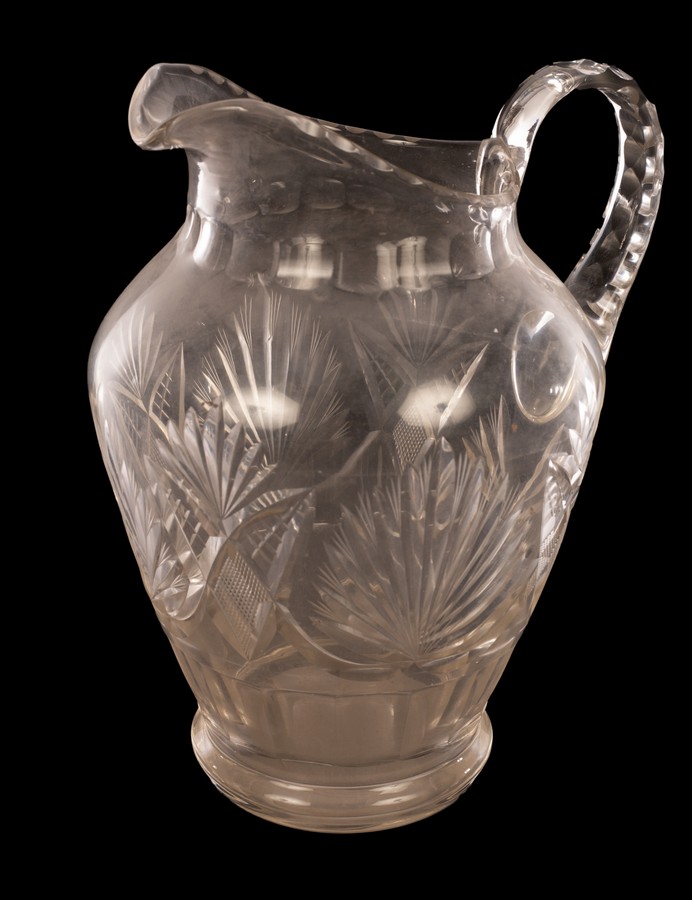 A large cut glass jug, fan pattern etc.