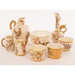 A Royal Worcester jug with gilt handle and rims, painted Oriental flowers on an ivory ground,