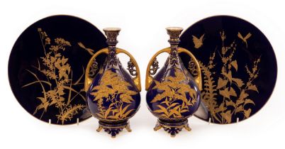 A pair of Royal Worcester pear-shaped vases of dark blue ground and gilded handles,